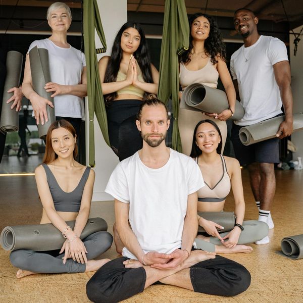 Group of diverse women smiling during a yoga class.